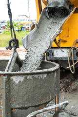Pouring cement down from the cement mixer truck in construction site