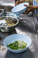 Chef cooking noodle soup. Thai street food on cart at night. Thai local food.