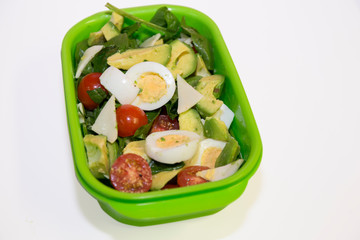 avocado, egg, cherry tomates, greens in the lunch box