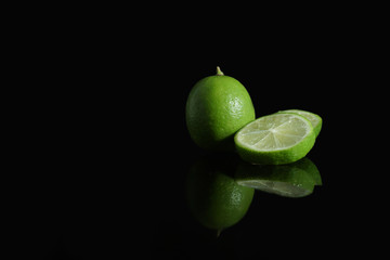 Green Lime with sliced on black background