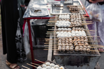 Thailand street food. Grilled food with sticks.