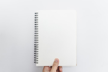 Hand holding opened blinder notebook, blank empty pages, on white background