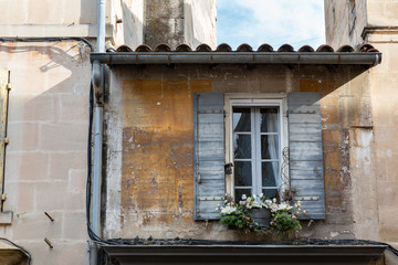 Fototapeta na wymiar Windowbox with flowers on an old building in St Remy, Provence, France