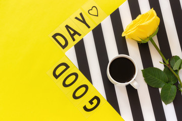 Text Good day, Coffee, and yellow rose on stylish black and white napkin on yellow background . Concept Flat lay Top view