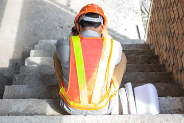 Stress engineer or architect holding hands at his head. He is having problems in work. He is...