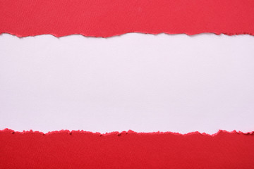 Torn red paper strip center ripped edge white background