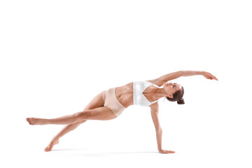 Sport girl doing yoga stretching exercise isolated.