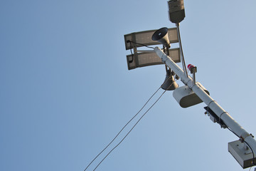 Obraz premium Solar street light and speaker on thin tower pole.