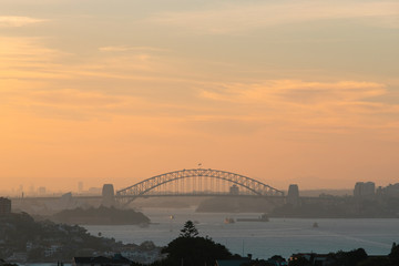 Naklejka premium Sydney Harbour Bridge with orange sky at sunset time.