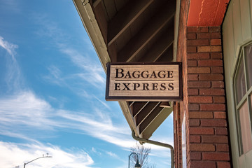 wooden sign that says Baggage Express outside of a train station