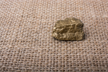 little gold color stone on a canvas