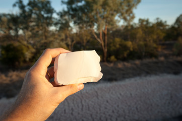 Solid block of mud being held by a person