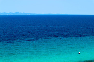Small white boat in the azure sea