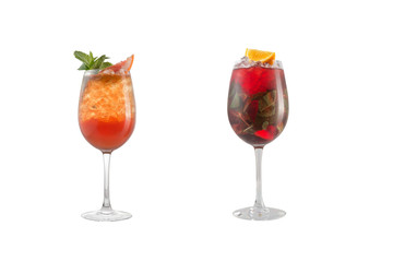 Alcohol cocktail with mint, fruit and berries on a white background. A set of two cocktails in glass goblets on a long leg.