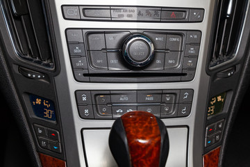 View to the interior of car with climate-controle, media system buttons after cleaning before sale on parking