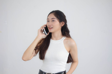 Portrait of thai china adult beautiful girl White shirt blue jeans calling smart phone