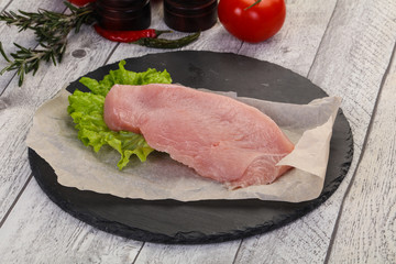 Raw Turkey steak served rosemary