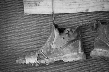 Old boots on a wire repaired with tape