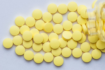 Yellow pills tablet on a white background.
