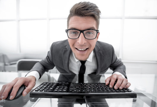 Crazy looking nerdy man typing on the keyboard