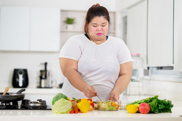 Fat Asian woman preparing in the kitchen