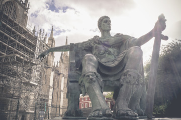 Vintage image, Statue of Roman Emperor Constantine the great with blue sky, York city, UK