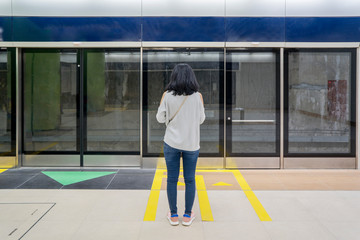 Female passenger waiting Jakarta MRT in station