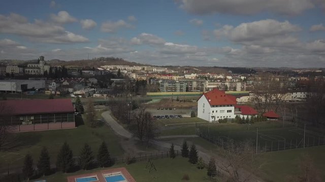 Gorlice, Poland - 3 9 2019: Panorama of the historic center of the European medieval city on the picturesque green hills. Trips to architectural monuments, temples, quarters and sports complex MOSiR
