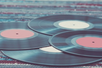 Old vinyl records, selective focus and toned image. Retro styled image of a collection of old vinyl records.