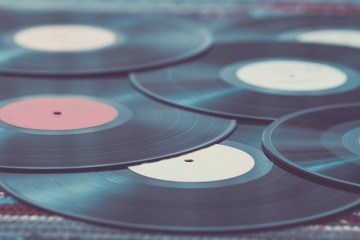 Old vinyl records, selective focus and toned image. Retro styled image of a collection of old vinyl...