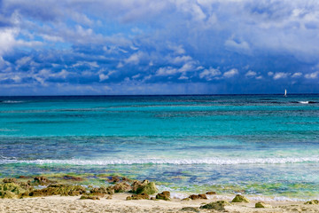 Tropical paradise, beach, white sand and blue sky with clouds.