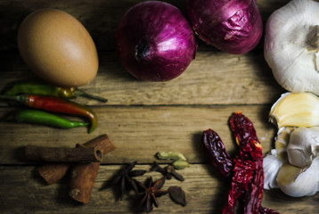 Closeup of various spices and common asian kitchen ingredients on wooden table. 