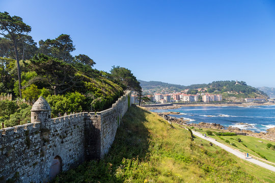 Baiona, Spain. View of the walls of the fortress of Monterreal on the sea and city