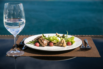 Meat salad and glass of still water. 
