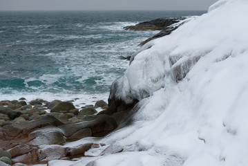 On the shore of the Barents Sea on a gloomy February day. Russia