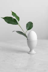 eggs in the standon marble background. Easter concept with copy space