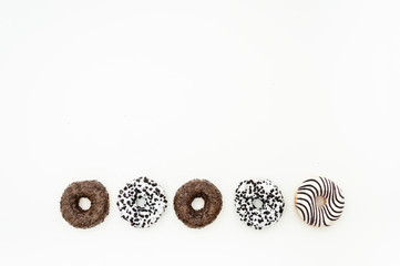 Donuts  with chocolate glazed with sprinkles donuts isolated on white black abstract background