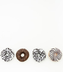 Donuts  with chocolate glazed with sprinkles donuts isolated on white black abstract background