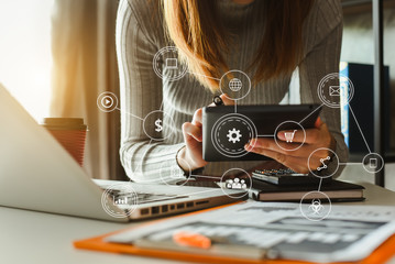 Businesswoman using mobile phone and laptop computer on white desk big data analytics with business intelligence concept. with VR chart and graph with icon