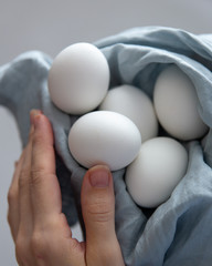 Fresh Eggs in woman hand. Easter concept with copy space