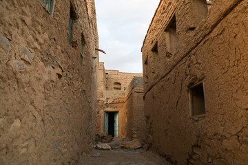 A corridor between ancient mud houses in the Sultanate of Oman