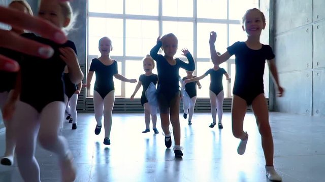 Little girls dance ballet. Children in ballet class.Little ballerinas and teacher. Beautiful view.