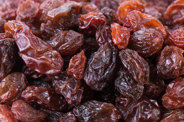 Black raisins background close-up. Dried grapes fruit. Top view.