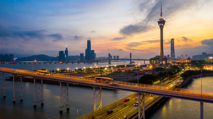 Fototapeta premium Macau city skyline at sunset with Macau Tower in twilight, Aerial view, Macau, China.