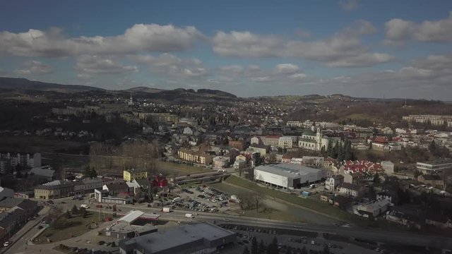 Gorlice, Poland - 3 9 2019: Panorama of the historic center of the European medieval city on the picturesque green hills. Trips to architectural monuments, temples, quarters and sports complex MOSiR