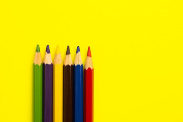 Coloring pencils on colorful background. School stationery and office supplies. Colored pencils abstract background. Lots of pencils of different colors. Creative flat lay.