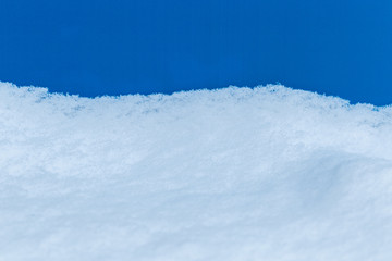 Fototapeta na wymiar White snowy fields under a blue background