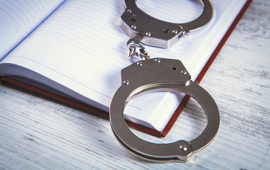 handcuff, wooden background