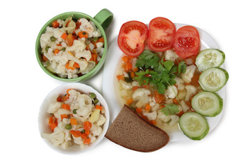 Porcelain plate with vegetable soup on white background