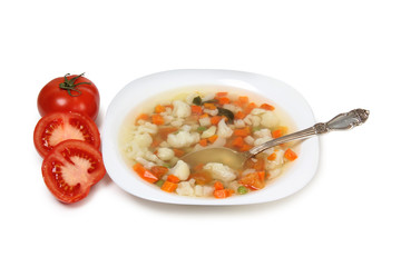 Porcelain plate with vegetable soup on white background